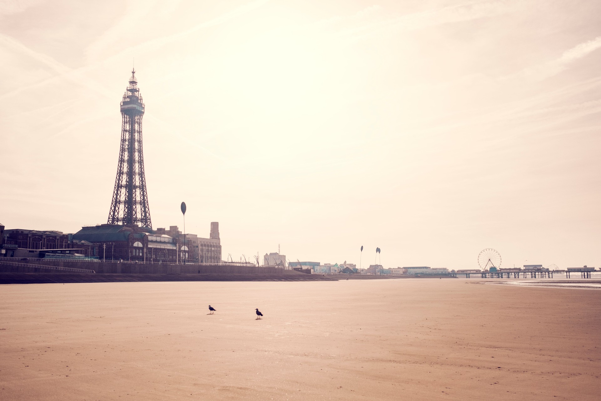 Views across Blackpool beach at low tide on a sunny morning.